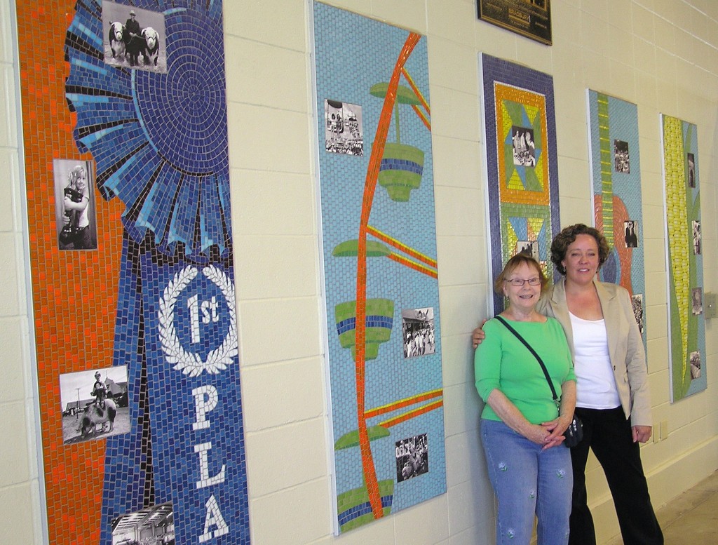 SAMA members Brenda Leslie (left) and Tina Murano in front of their five-panel mosaic project at the 2013 Kansas State Fair. 